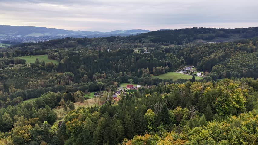 Breathtaking aerial view showcasing the lush greenery and stunning hilly landscape beneath a cloudy sky above