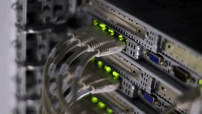A detailed shot of network cables plugged into a server rack, with green indicator lights blinking, symbolizing data transfer and the intricate workings of a modern data center or IT infrastructure. - Powered by Shutterstock - Get 15% off with code: PIKWIZARD15