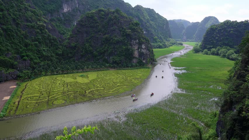 Tam Coc landscape with limestone mountains, river and rice field on Ngo Dong stream, Ninh Binh, Vietnam