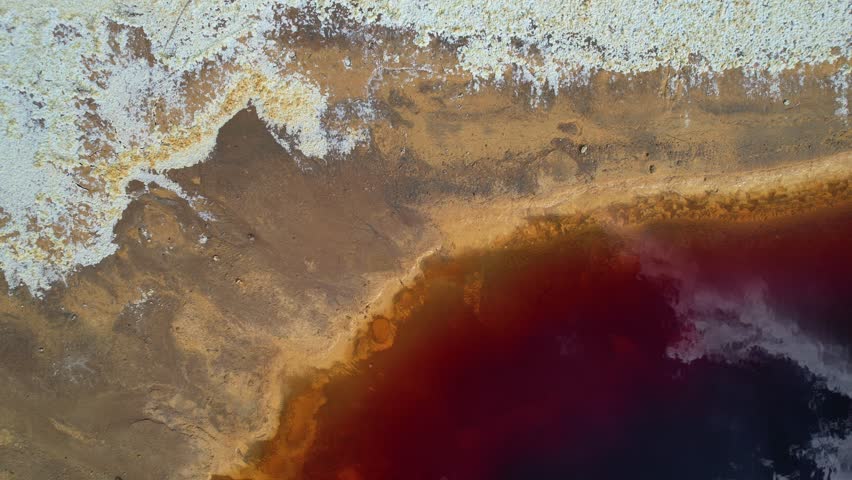 Drone 4k aerial footage of toxic red lake from abandoned mine. Nature disaster water contamination