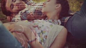 Animation of financial data processing over caucasian couple having picnic in park. Global finances, lifestyle, computing and digital interface concept digitally generated video. - Powered by Shutterstock - Get 15% off with code: PIKWIZARD15