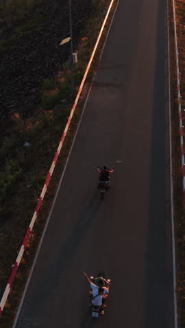 A motorcyclist enjoying a scenic ride during sunset on a road next to a dam crest