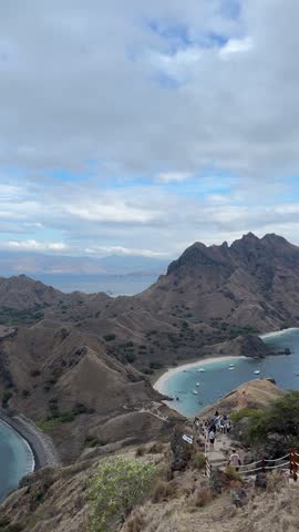 Stunning panoramic views of the beautiful Padar Island and rolling hills under clear, cloudless skies.