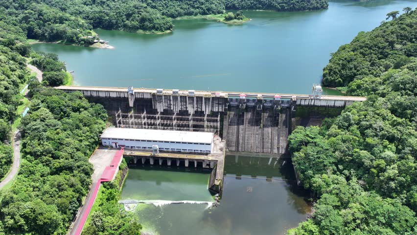 4k aerial video footage flying above River "Rio Chepo" and  Bayano Dam with Hydroelectric Power Plant towards Bayano Lake in Panama with rainforest and jungle landscape around the lake