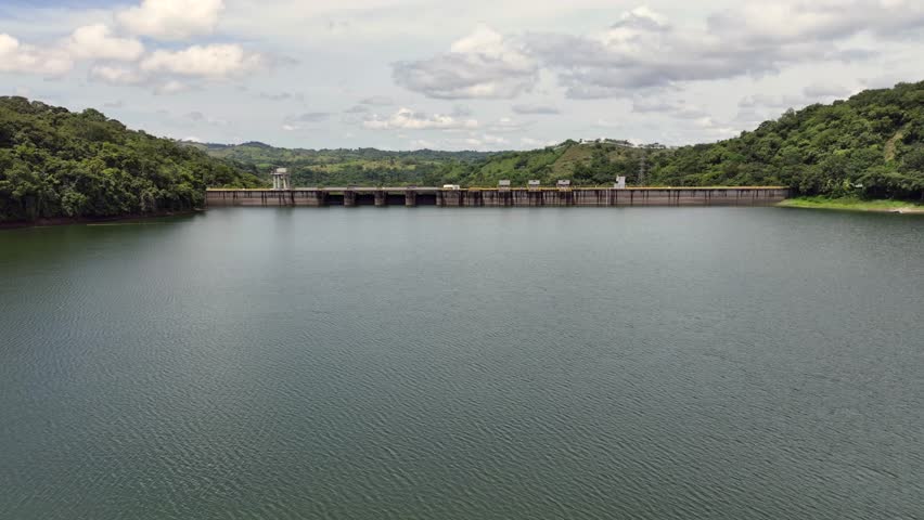 low level flying across Bayano Lake towards Bayano Dam with Hydroelectric Power Plant in Panama with rainforest and jungle landscape around the lake - 4k aerial video footage