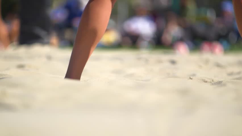 Close up of feet in the sand playing volleyball