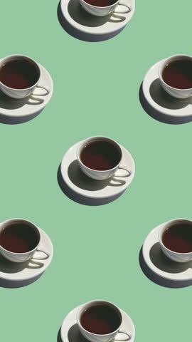 Seamless pattern of white cups with tea with strong shadows on a green background. Tea mugs move in different directions, vertical footage
