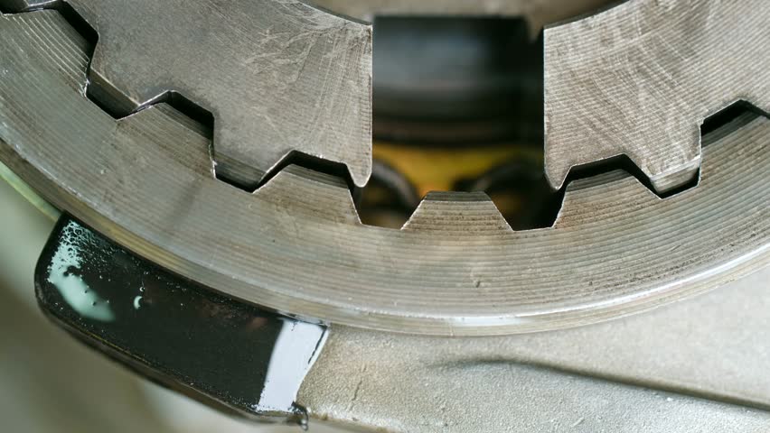 Extreme close up complex metal gear wheel rotating inside machine, showcasing intricate industrial mechanism, precision engineering of machinery in motion. Close up of rotating machine gear mechanism