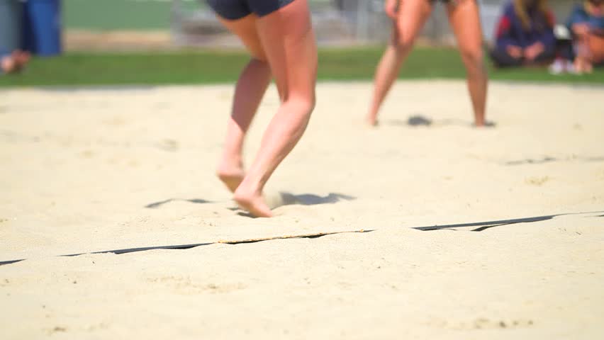 Close up of feet in the sand playing volleyball