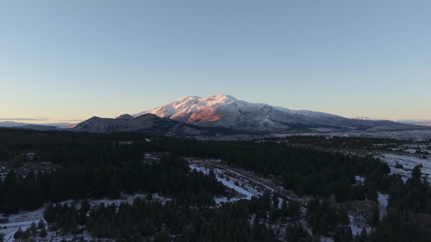 Aerial view of majestic Andes mountain range and peak by soft evening sunlight, Chubut Province, Argentina.