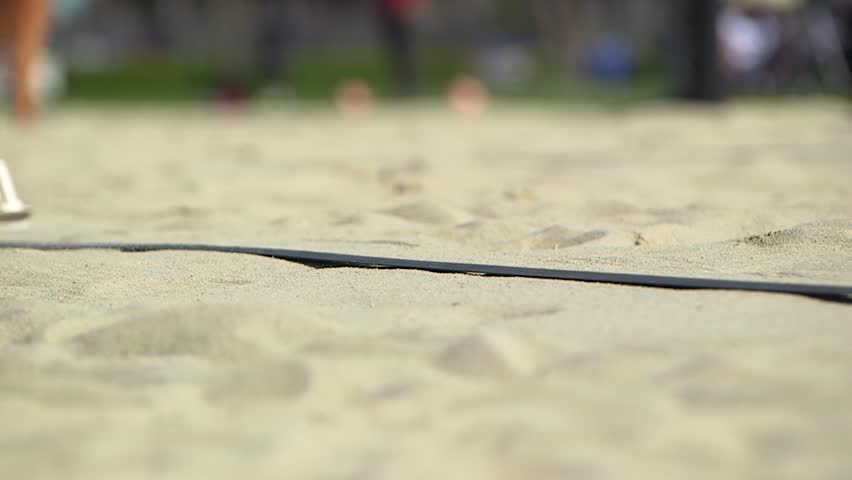 raking the sand on beach volleyball court