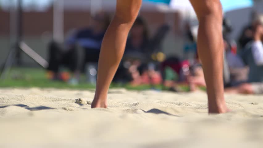 Close up of feet in sand playing volleyball