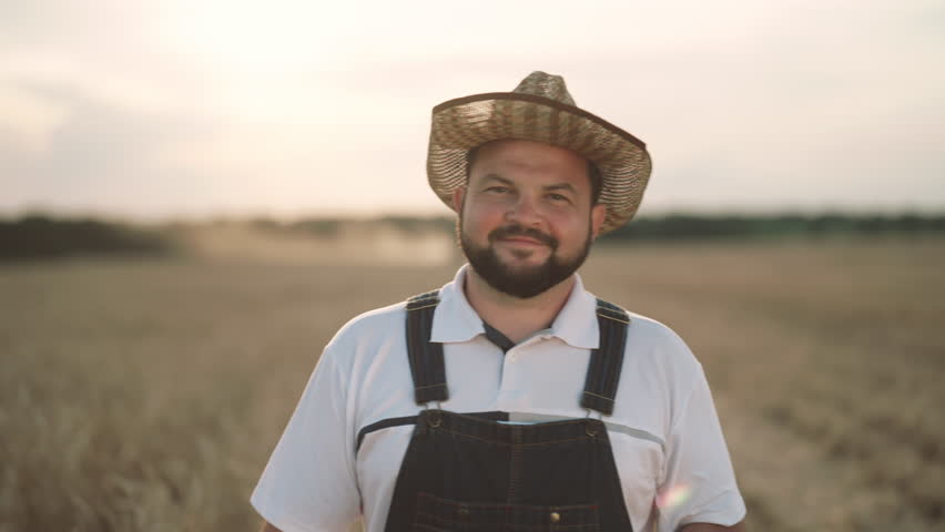 Agribusiness and agriculture, portrait of happy farmer with tablet in fields. Growing cereals for food industry, walk in beautiful rye and wheat farmland in summer day, traditions and innovation