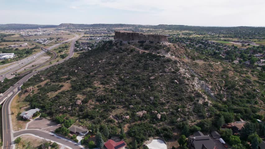 Aerial video of the famous Castle Rock Park in Castle Rock, Colorado. Camera is heading approximately north out of the city toward Castle Rock Park.