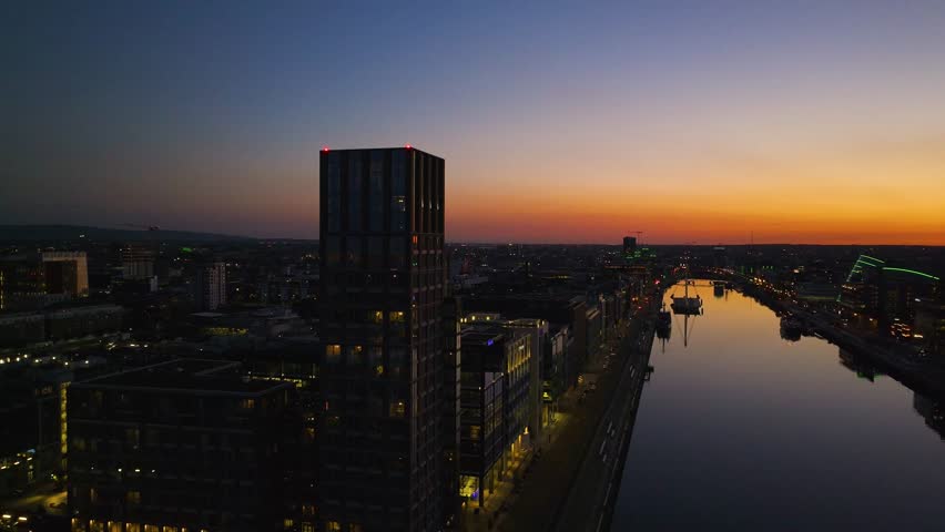 4K cinematic drone footage capturing a golden sunset over Dublin with stunning reflections on the River Liffey. Co.Dublin - Ireland_229