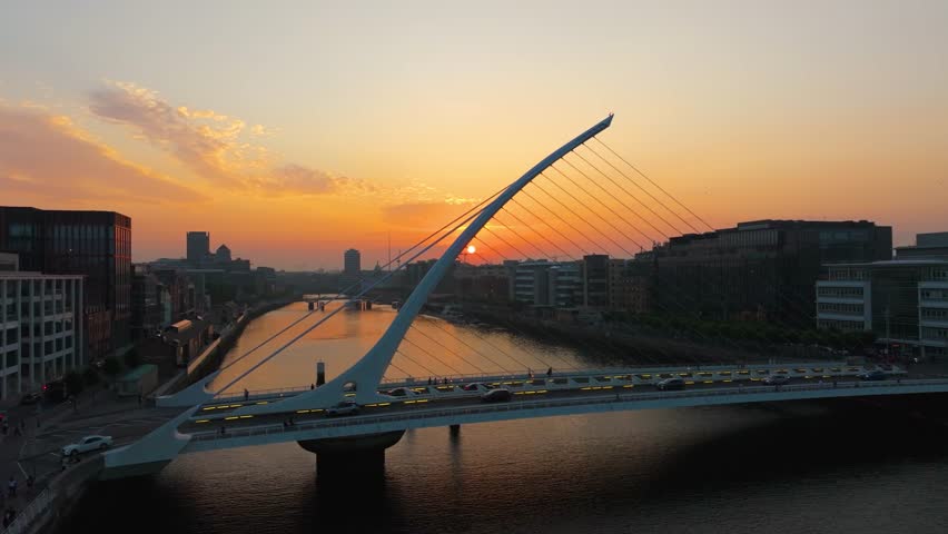 4K cinematic drone footage capturing a golden sunset over Dublin’s Samuel Beckett Bridge with stunning reflections on the River Liffey. Co. Dublin, Ireland_201