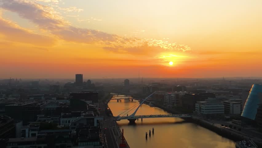 4K cinematic drone footage capturing a golden sunset over Dublin’s Samuel Beckett Bridge with stunning reflections on the River Liffey. Co. Dublin, Ireland_205