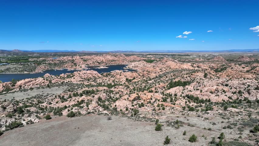 Aerial view of Watson Lake surrounded by unique rock formations under a clear blue sky, a mesmerizing landscape, Watson Lake, Arizona, United States.