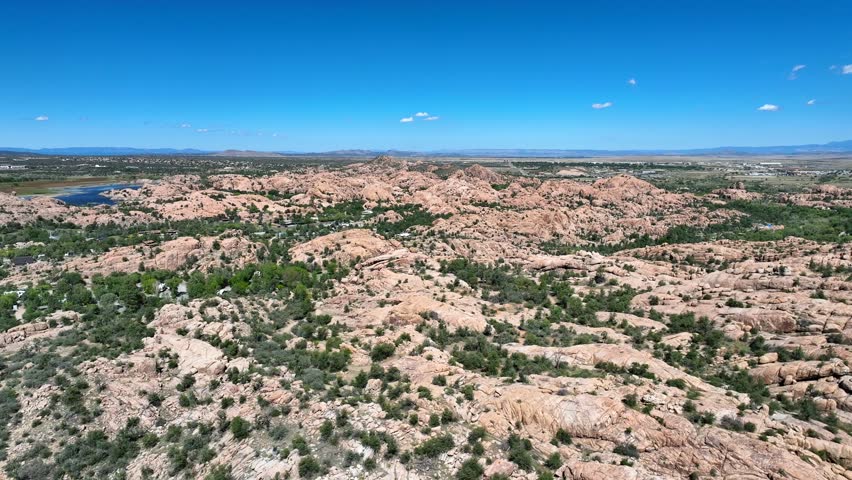 Aerial view of Watson Lake nestled amidst the rugged terrain, with a striking contrast between the blue water and the surrounding rocks, Watson Lake, Arizona, United States.
