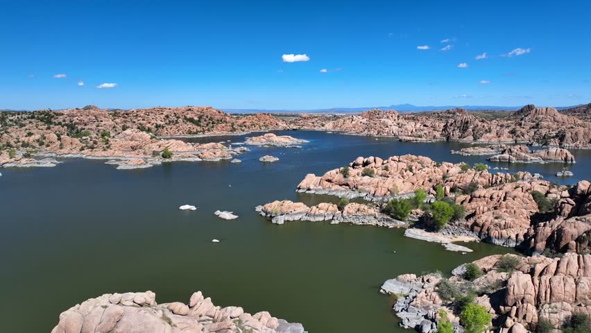 Aerial view of Watson Lake with its distinctive rock formations nestled amid the serene waters under a clear blue sky, Watson Lake, Arizona, United States.