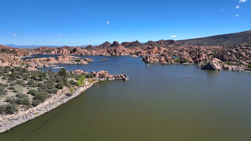 Aerial view of Watson Lake surrounded by rugged terrain, where the tranquil waters meet the unique rock formations, creating a stunning contrast, Watson Lake, Arizona, United States.