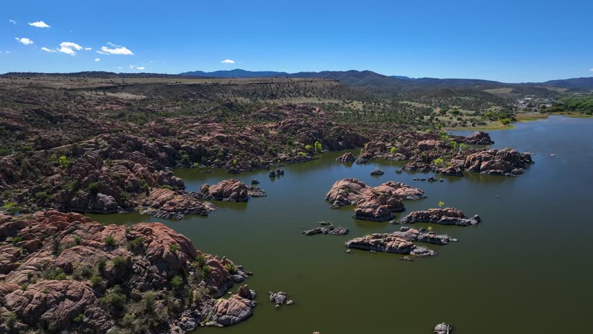 Aerial view of Watson Lake showcasing the contrasting colors of the red-brown rocks against the greenish water, Watson Lake, Prescott, Arizona, United States.