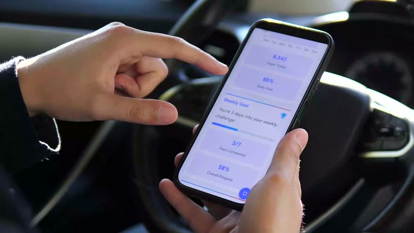 A health-conscious individual achieves his fitness target, confirmed by a congratulatory message on his phone app, leading to a triumphant gesture. This clip is excellent for inspiring stories about