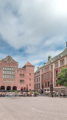 Hyperlapse of Beursplein with the historic Beurs van Berlage building, a former commodity exchange, now a venue for concerts and exhibitions. People walking across the square. Amsterdam, Netherlands