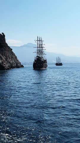 Ocean splashes around a big rock in the middle of the sea. Island in the ocean