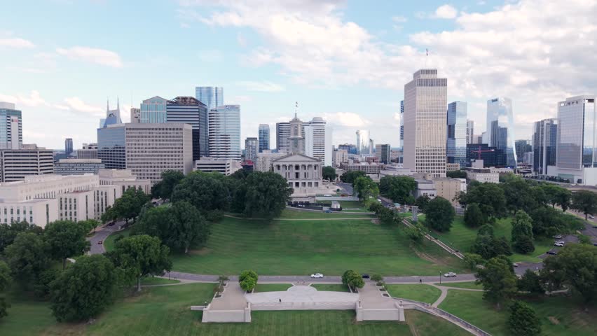 The Tennessee State Capitol Building And Downtown Nashville City Skyline. Rising Aerial Shot.