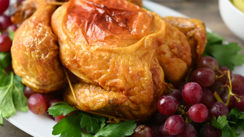 Thanksgiving dinner on rustic wooden table with roasted turkey,mashed potatoes,ears of corn and green bean casserole	