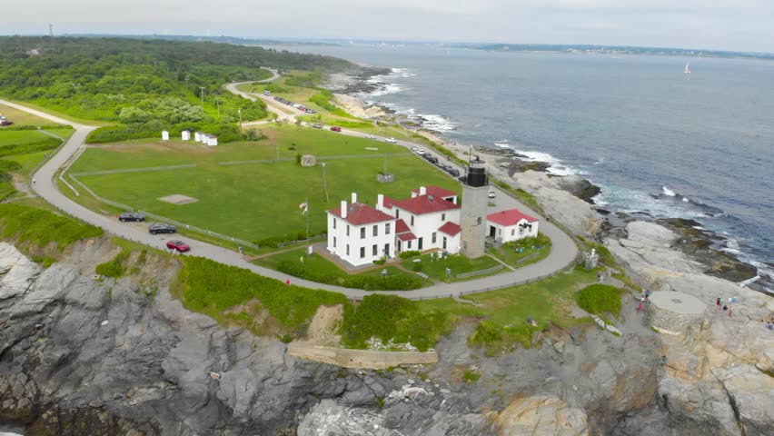 Stunning drone footage orbiting a lighthouse on a scenic peninsula in Jamestown, Rhode Island. Perfect for coastal landscapes, travel, and aerial footage.