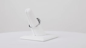 Elegant sapphire ring spinning slowly on a jewelry stand against a clean white background. - Powered by Shutterstock - Get 15% off with code: PIKWIZARD15