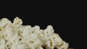 Salted white popcorn kernels on a black background, showcasing large, fluffy texture and natural snack appeal—ideal for food photography, healthy eating visuals, and cinematic close-ups. - Powered by Shutterstock - Get 15% off with code: PIKWIZARD15