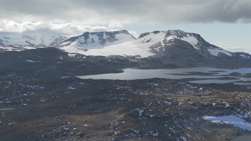 Forward flying drone footage of mountain peaks an glaciers in Jotunheimen National Park