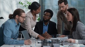 African American leader listen colleagues employers team in office Caucasian Indian business men women analysing document paperwork together businesspeople discussion multiethnic workers planning work - Powered by Shutterstock - Get 15% off with code: PIKWIZARD15