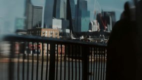 Modern glass skyline and red cranes reflected with blurred railing, abstract riverside city scene mixes movement and architecture. - Powered by Shutterstock - Get 15% off with code: PIKWIZARD15