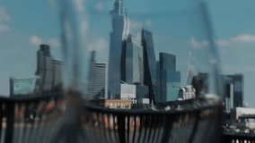 Blurred reflection of a man in sunglasses overlays riverside railing with modern skyline, creating surreal urban portrait. - Powered by Shutterstock - Get 15% off with code: PIKWIZARD15