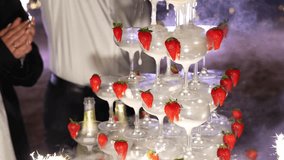 A scenic view of a champagne pyramid decorated with strawberries and fire from the both sides - Powered by Shutterstock - Get 15% off with code: PIKWIZARD15