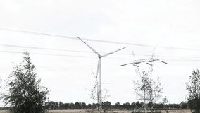 Wind Power. Turbines and Power Lines Against the Sky. large windmills(wind turbines generating power in a vast field. Industrial Energy Landscape. - Powered by Shutterstock - Get 15% off with code: PIKWIZARD15