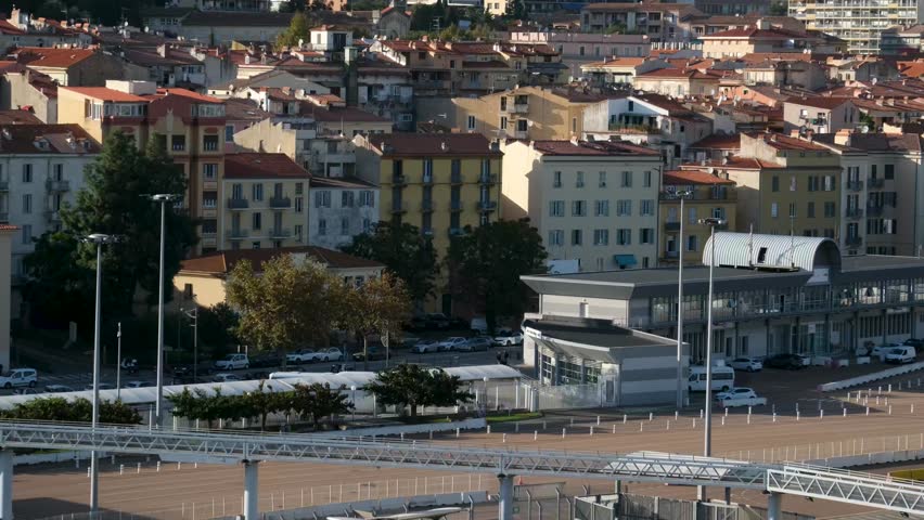 Scenic coastline of Corsica island seen from cruise ship with green hills rocky cliffs turquoise sea and coastal towns in sunlight Mediterranean travel destination natural landscape and summer view