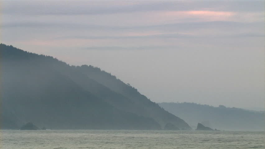 Pan across coastline of the mountain