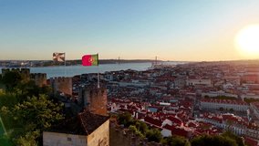 A scenic drone panorama of Lisbon Alfama neighborhood at dusk, glowing rooftops and river backdrop - Powered by Shutterstock - Get 15% off with code: PIKWIZARD15