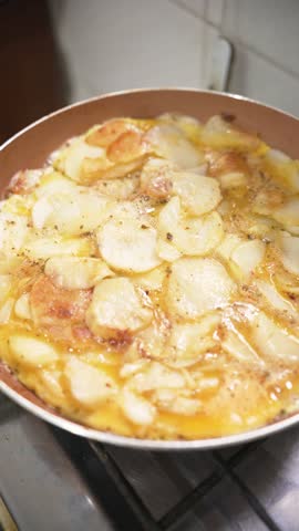 Vertical video of a pan cooking Spanish 