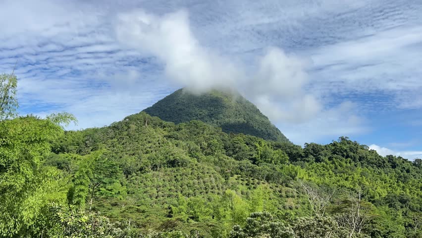 Clouds moving around the peak of Cerro Tusa, the pyramid-shaped mountain near Venecia in the Antioquia region of Colombia