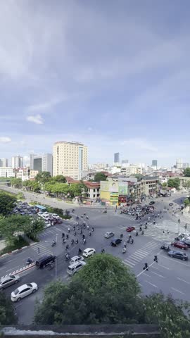 Hanoi, Vietnam – October 8, 2024: Busy street traffic in downtown Hanoi with cars driving through the city