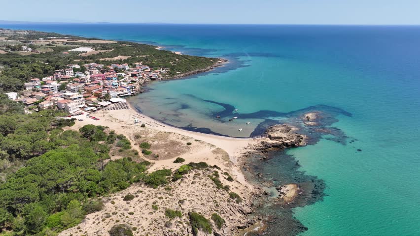 Aerial drone cinematic video of small seaside village and circular sandy beach of Arkoudi in Western Peloponnese, Ilia prefecture, Greece