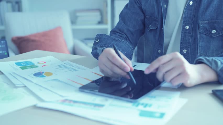 Recruiter using data and technology for candidate selection, screening resumes for a business hiring project.