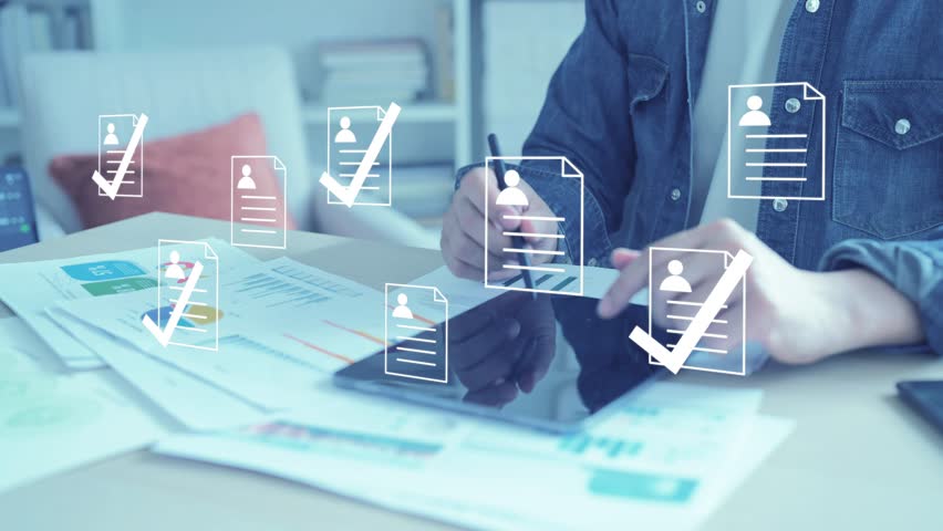 Recruiter using data and technology for candidate selection, screening resumes for a business hiring project.