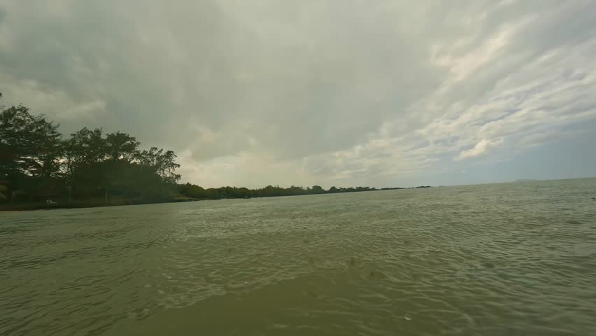 A serene landscape with a large water body and lush trees